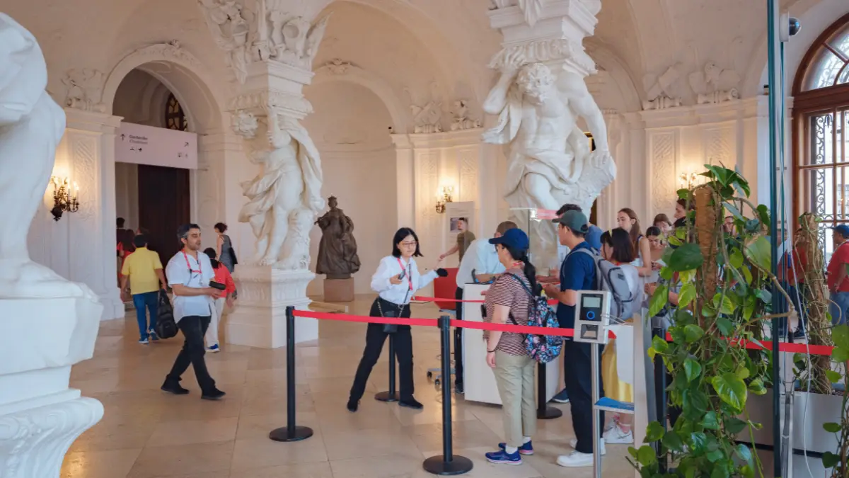 ourists waiting in line inside Belvedere Palace for skip-the-line entry.