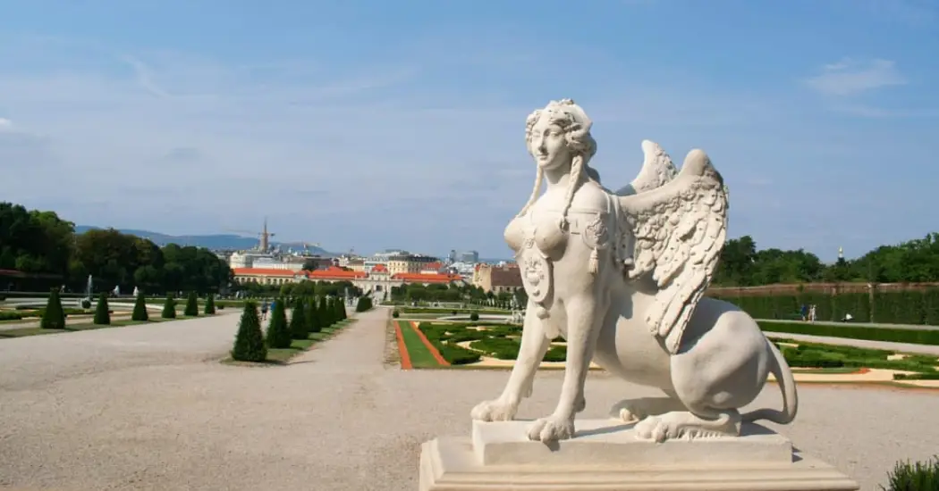 A white sphinx statue in the Belvedere Palace garden.