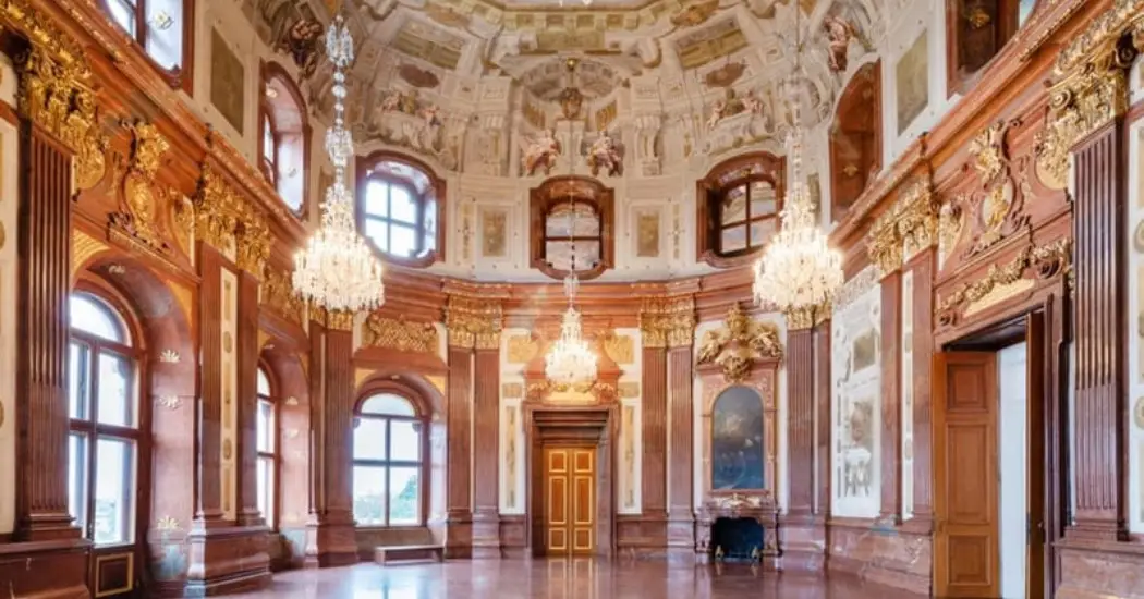 Interior of the belvedere palace with dramatic ceiling frescoes.