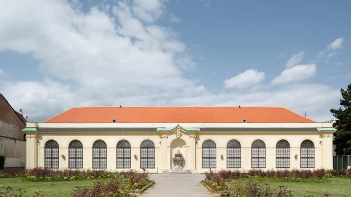 Front view of the Orangery at Belvedere Palace with a red roof.