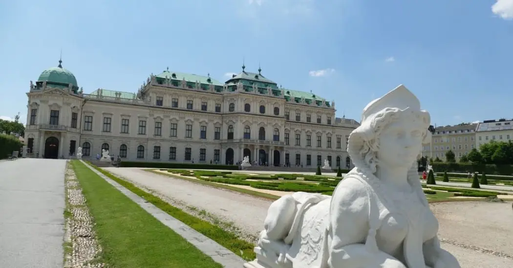 View of Upper Belvedere Palace with a Baroque sphinx sculpture in the foreground. View of Upper Belvedere Palace with a Baroque sphinx sculpture in the foreground.
